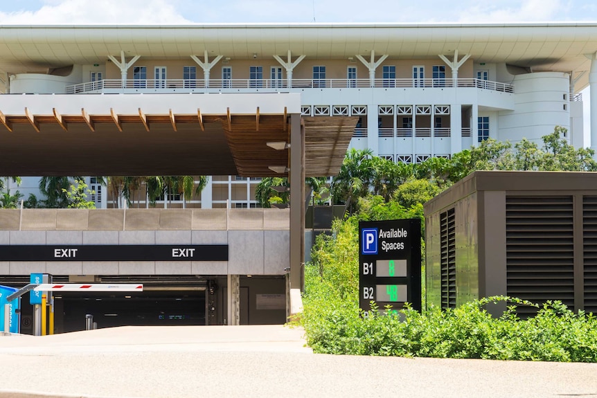 A car park beneath a large building.